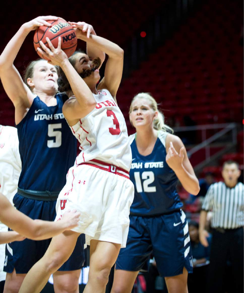 Lennie Mahler  |  The Salt Lake Tribune

Utah State's Shannon Dufficy forces a jump ball as Utah's Malia Nawahine shoots in a game at the Huntsman Center in Salt Lake City, Saturday, Dec. 3, 2016.