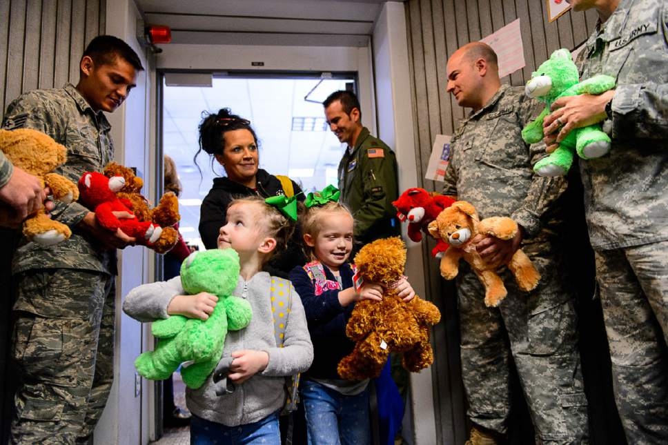 Trent Nelson  |  The Salt Lake Tribune
Presley and Liberty Parker embrace teddy bears given to them by servicemen before takeoff at the Salt Lake City International Airport, Sunday December 11, 2016. About 20 Utah children and adults will join about 1,800 peers in Dallas as part of the 11th Annual Snowball Express. Snowball Express is a nonprofit organization with the goal of ìServing the Children of Our Fallen Military Heroes.î Brook Parker, the girls' mother, is behind them.