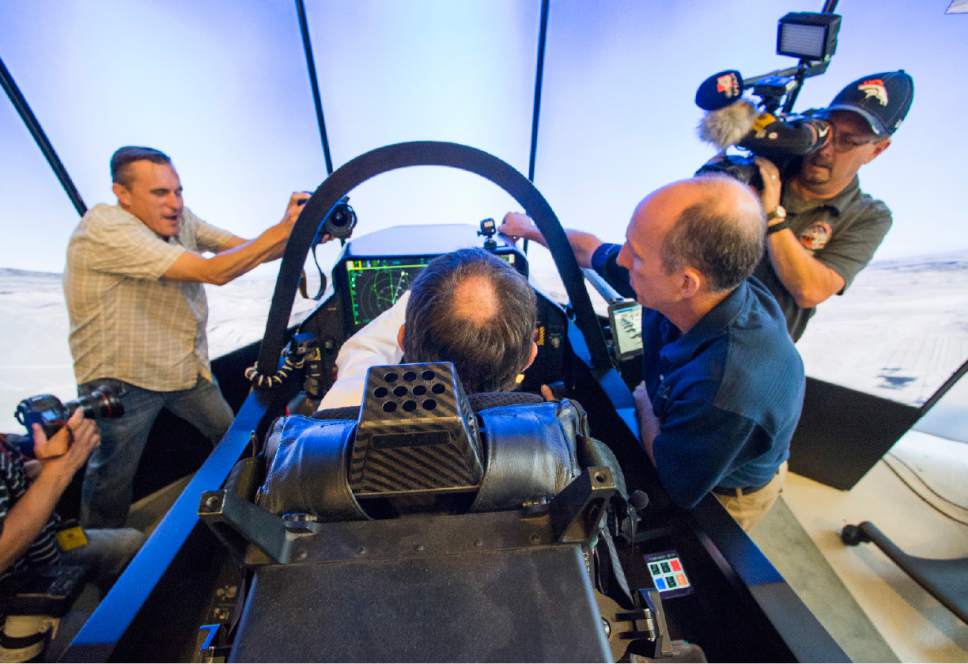Rick Egan  |  The Salt Lake Tribune

F-35 Cockpit Simulator Pilot Eric Best (right) gives Gov. Gary Herbert some instructions to University of Utah Engineering graduate student, Beau Freckleton, as he sits in the cockpit of the F-35 simulator.  Lockheed Martin and Hill Air Force Base teamed up to bring the F-35 interactive cockpit demonstrator to the University Of Utah Wednesday, October 7, 2015.