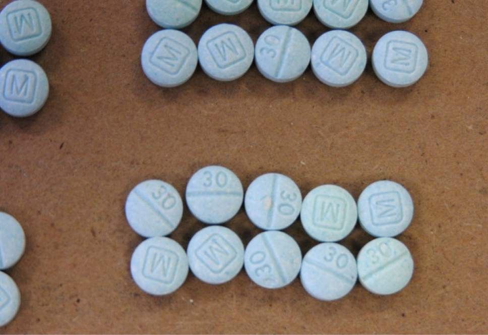 This undated photo provided by the Cuyahoga County Medical Examiner's Office shows fentanyl pills. Authorities say they've arrested Ryan Gaston, a man in a Cleveland suburb after seizing more than 900 fentanyl pills marked liked tablets of the less-potent opiate oxycodone. The Cuyahoga County medical examiner said that lookalike pills were likely to blame for some of the county's 19 fentanyl-related overdose deaths in January 2016. (Cuyahoga County Medical Examiner's Office via AP)