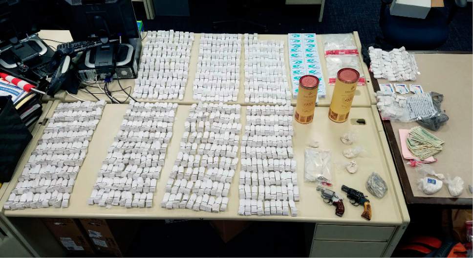 FILE - In this Tuesday, Sept. 13, 2016, file photo released by the Hartford Police Department shows items seized in a drug raid in the Asylum Hill neighborhood in Hartford, Conn. Deputy Chief Brian Foley said multiple officers became ill when they were exposed to heroin and fentanyl during the bust. The officers were treated at a hospital and released. Facing what's been called an opioid drug epidemic, Utah police, prosecutors and politicians are set to speak about how to investigate and prosecute heroin and other drug cases at the Utah Heroin and Opioid Summit in Salt Lake City. (Hartford Police Department via AP, File)