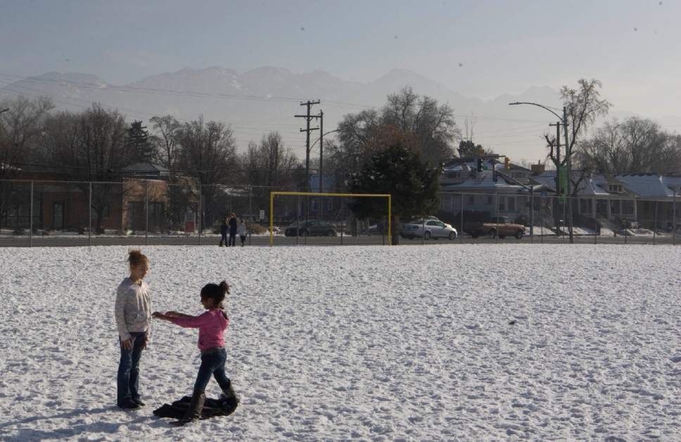 Keith Johnson | The Salt Lake Tribune

Inversion partially obscures the Wasatch Mountains as Hawthorne Elementary School students enjoy recess, December 17, 2013 in Salt Lake City.