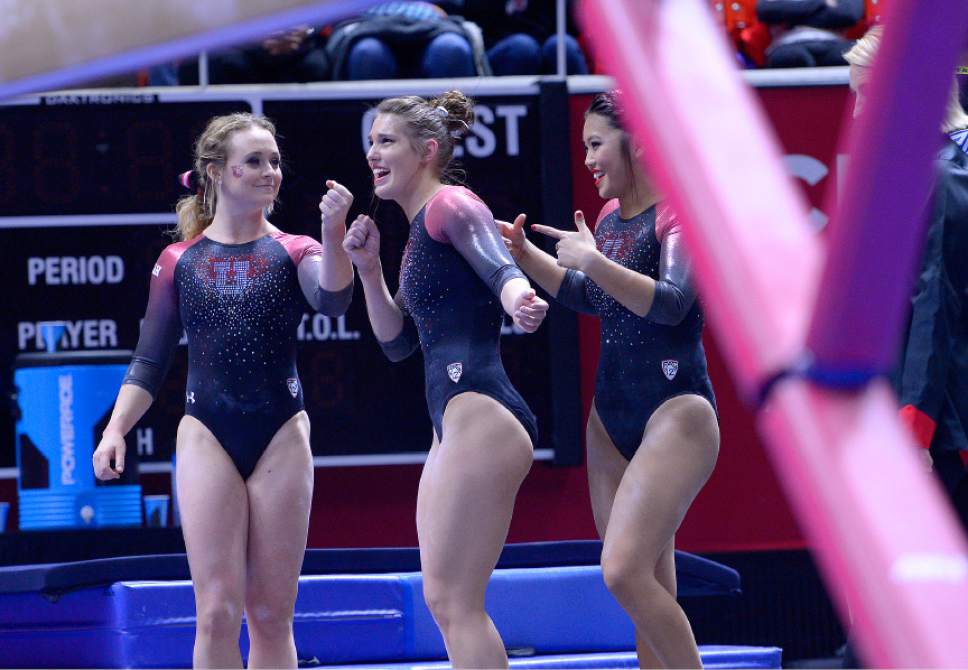 Leah Hogsten  |  The Salt Lake Tribune
l-r Maddy Stover holds the mic for Baely Rowe while Kari Lee points to her teammate while singing and dancing during the preview. University of Utah gymnastics fans got their first glimpse of this year's team at the Red Rocks Preview intrasquad meet at the Huntsman Center, Friday, December 9, 2016.