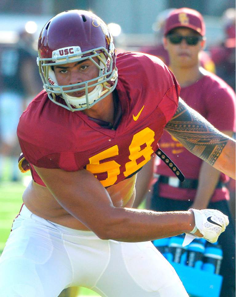 FILE - In this Aug. 30, 2016 file photo, Southern California's Osa Masina works out during NCAA college football practice in Los Angeles. He is one of two USC football players under investigation for sexual assault. The team has sent linebacker Don Hill home from Dallas, where the No. 20 Trojans are set to open the season Saturday, Sept. 3, against No. 1 Alabama. The team on Friday would say only that Hill had violated team rules. Masina did not make the trip with the team. (John McCoy/Los Angeles Daily News via AP, File)