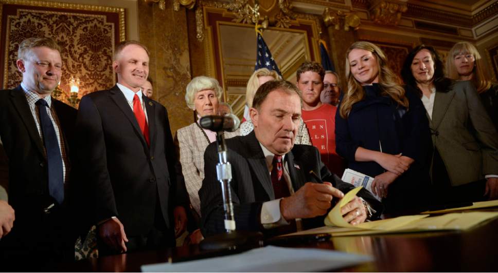 Al Hartmann  |  Tribune file photo
Gov. Gary Herbert, center, signed ceremonial copies of resolutions earlier his year declaring pornography a "public health crisis." The nonbinding resolutions contained no state funding. Now, in his recently released budget, Herbert has requested $50,000 for anti-porn efforts. Community activist Pamela Atkinson, standing behind Herbert, said the money is needed and, if approved, would go for a good cause.
