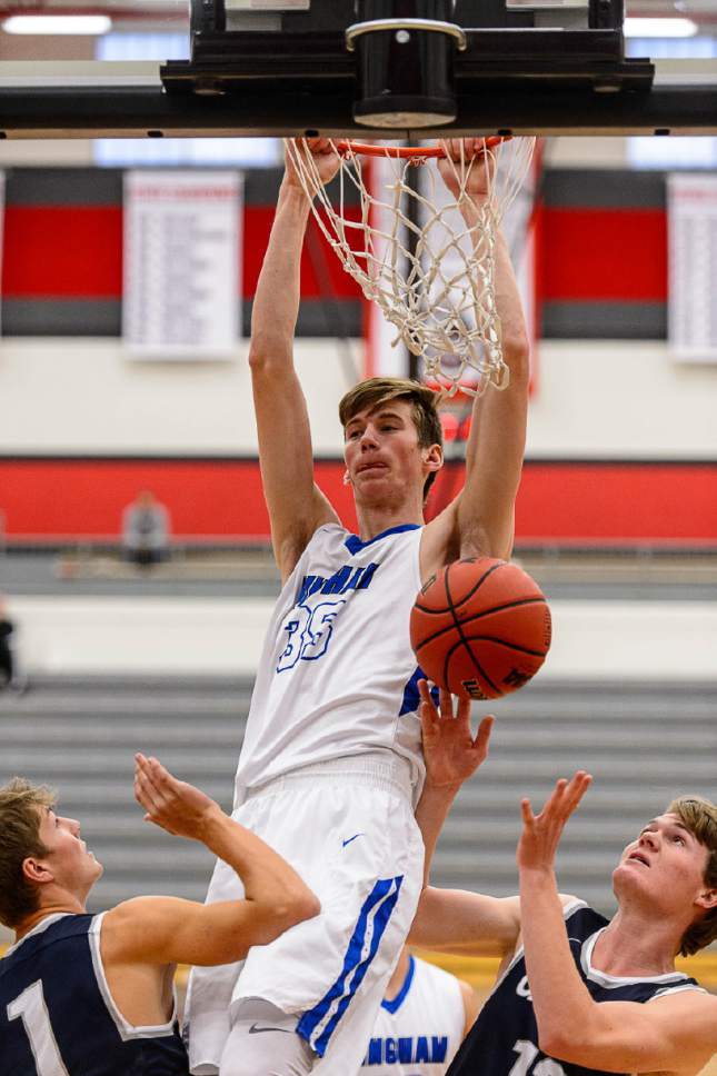 Trent Nelson  |  The Salt Lake Tribune
Bingham's Branden Carlson dunks the ball over Corner Canyon's Zach Wilson and Ammon Savage as Bingham faces Corner Canyon in the first round of the Utah Elite 8 boys' basketball tournament at American Fork High, Thursday December 8, 2016.