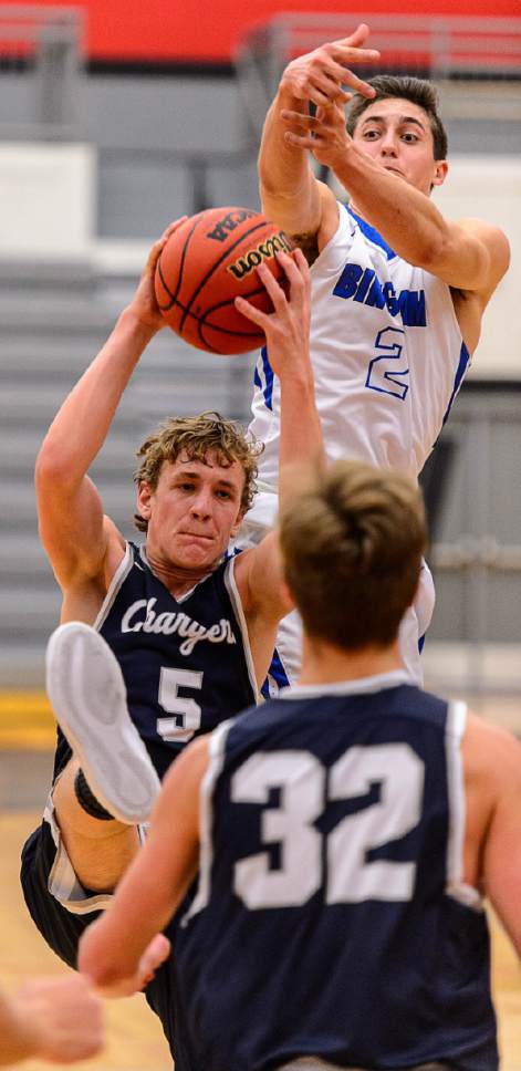 Trent Nelson  |  The Salt Lake Tribune
Corner Canyon's Michael Scheffner and Bingham's Lleyton Parker reach for the ball as Bingham faces Corner Canyon in the first round of the Utah Elite 8 boys' basketball tournament at American Fork High, Thursday December 8, 2016.