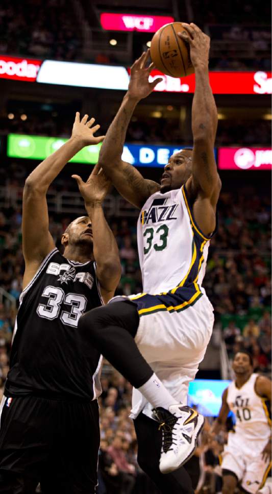 Lennie Mahler  |  The Salt Lake Tribune

Jazz forward Trevor Booker drives by Spurs forward Boris Diaw in the first half of a game at EnergySolutions Arena in Salt Lake City on Monday, Feb. 23, 2015.