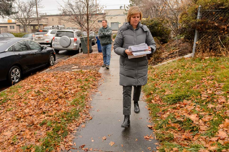 Trent Nelson  |  The Salt Lake Tribune
Salt Lake City Councilwoman Lisa Adams goes door-to-door in the area around 653 E. Simpson Avenue to explain to residents what they should expect from the planned homeless shelter at that address, Wednesday December 14, 2016. She was accompanied by Detective Keith Peterson after receiving threatening emails.