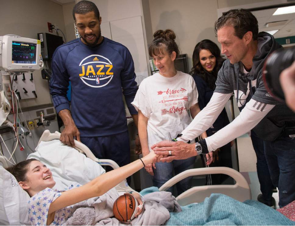 Leah Hogsten  |  The Salt Lake Tribune
l-r Reagan Perkins is wished a speedy recovery by Utah Jazz player Derrick Favors and head coach Quin Snyder after a visit short visit with her and her mother Erin Perkins. Players from the Utah Jazz, Salt Lake City Stars players and coaches, Jazz Dancers, Jazz Bear and members of the Wheeliní Jazz  visited Primary Childrenís Hospital, Thursday, Dec. 15, 2016. The annual Christmas hospital visits are part of the NBA Cares Season of Giving and allow the organization to deliver holiday cheer to patients and their families.