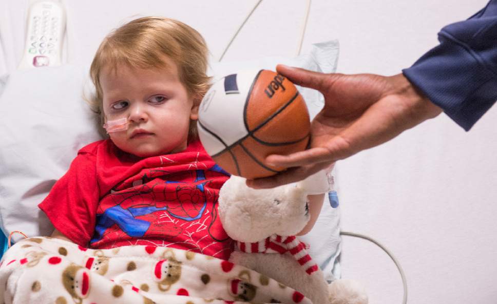 Leah Hogsten  |  The Salt Lake Tribune
Kannon Klein, 2, is too shy to reach out to the basketball that Rodney Hood gives him. Players from the Utah Jazz, Salt Lake City Stars players and coaches, Jazz Dancers, Jazz Bear and members of the Wheelin' Jazz  visited Primary Children's Hospital, Thursday, Dec. 15, 2016. The annual Christmas hospital visits are part of the NBA Cares Season of Giving and allow the organization to deliver holiday cheer to patients and their families.