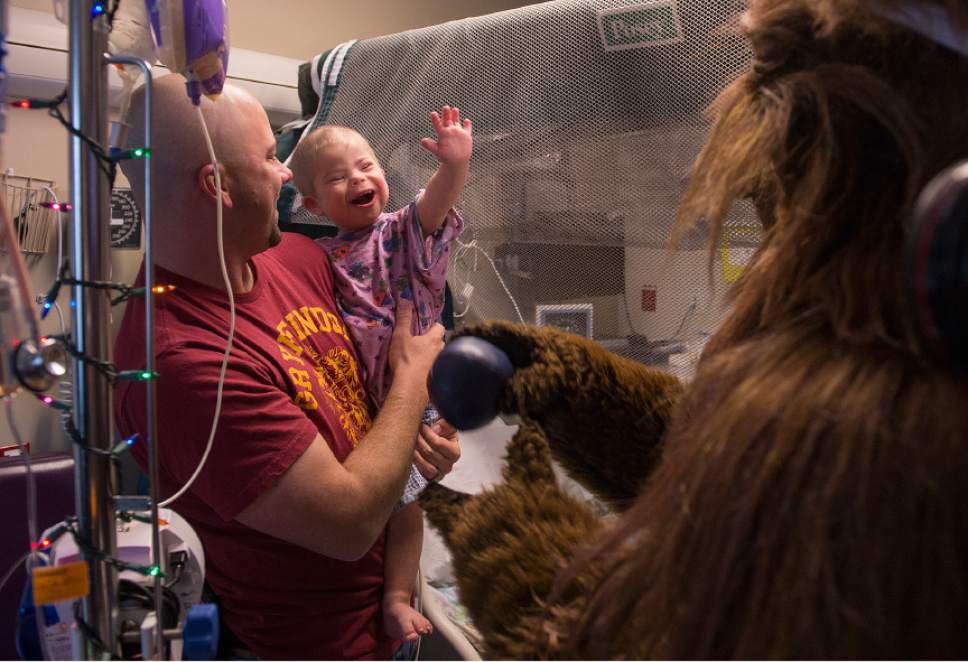 Leah Hogsten  |  The Salt Lake Tribune
Kellen Hedler, 3, reaches out to high-five Utah Jazz Bear during a short visit with he and his father Michael Hedler. Players from the Utah Jazz, Salt Lake City Stars players and coaches, Jazz Dancers, Jazz Bear and members of the Wheelin' Jazz  visited Primary Children's Hospital, Thursday, Dec. 15, 2016. The annual Christmas hospital visits are part of the NBA Cares Season of Giving and allow the organization to deliver holiday cheer to patients and their families.