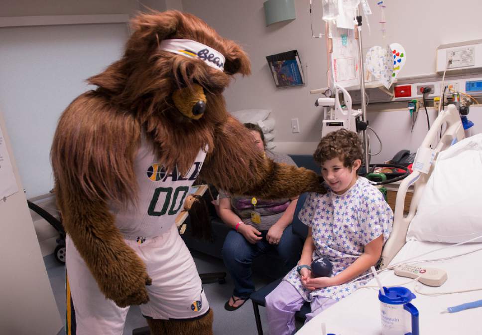 Leah Hogsten  |  The Salt Lake Tribune
Utah Jazz Bear says goodbye to Maddy McEwan, 10, after visiting with her in her room at Primary Children's Hospital.  Players from the Utah Jazz, Salt Lake City Stars players and coaches, Jazz Dancers, Jazz Bear and members of the Wheelin' Jazz  visited Primary Children's Hospital, Thursday, Dec. 15, 2016. The annual Christmas hospital visits are part of the NBA Cares Season of Giving and allow the organization to deliver holiday cheer to patients and their families.