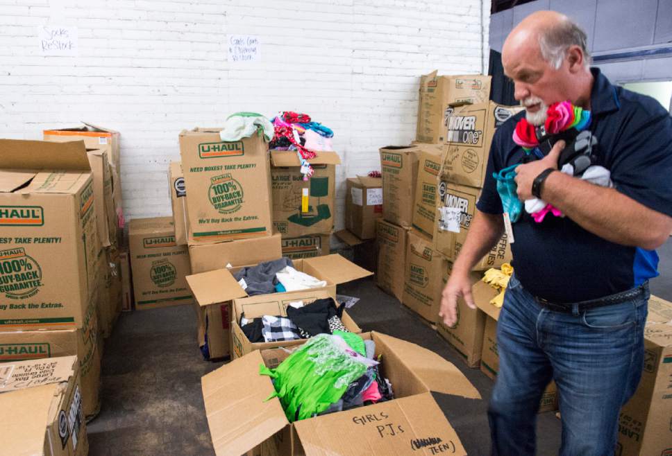 Rick Egan  |  The Salt Lake Tribune

Brad Pizza, a volunteer from Cottonwood Insurance, sorts clothing at the Candy Cane Corner, which gives homeless families an opportunity to shop for Christmas, Friday, December 2, 2016.