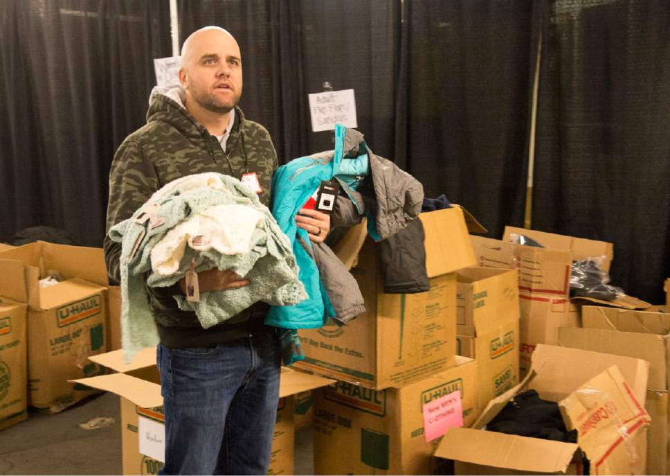 Rick Egan  |  The Salt Lake Tribune

Kris Stewart , a volunteer from Cottonwood Insurance, looks for the proper boxes, as he sorts clothing at the Candy Cane Corner, which gives homeless families an opportunity to shop for Christmas, Friday, December 2, 2016.