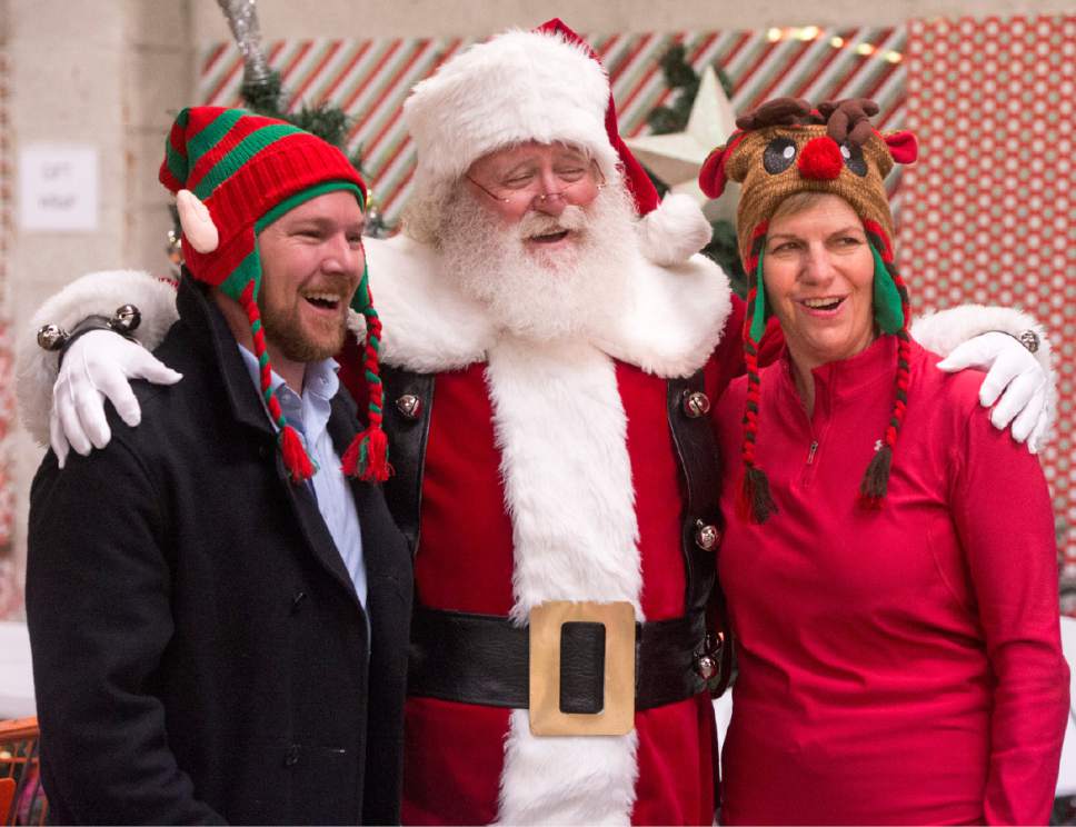 Rick Egan  |  The Salt Lake Tribune

Andrew Johnston, Salt Lake City Council, poses for a photo with Santa along with Lisa Adams, Chair, RDA, at the Candy Cane Corner, which gives homeless families an opportunity to shop for Christmas, Friday, December 2, 2016.