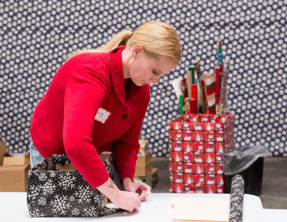 Rick Egan  |  The Salt Lake Tribune

Mary Kelsey, a volunteer from Cottonwood Insurance, wraps packages at the Candy Cane Corner, which gives homeless families an opportunity to shop for Christmas, Friday, December 2, 2016.