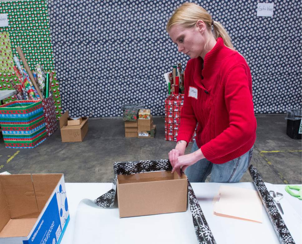 Rick Egan  |  The Salt Lake Tribune

Mary Kelsey, a volunteer from Cottonwood Insurance, wraps presents at the Candy Cane Corner, which gives homeless families an opportunity to shop for Christmas, Friday, December 2, 2016.