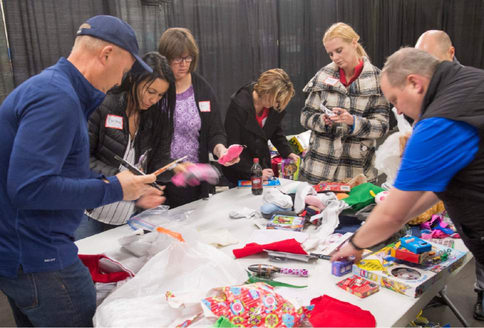 Rick Egan  |  The Salt Lake Tribune

Volunteer from Cottonwood Insurance, wrap presents at the Candy Cane Corner, which gives homeless families an opportunity to shop for Christmas, Friday, December 2, 2016.