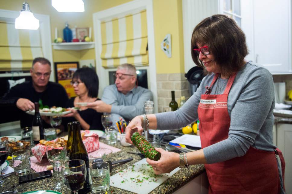 Chris Detrick  |  The Salt Lake Tribune
Cooking instructor Marguerite Henderson rolls goat cheese in pink peppercorns and parsley during a class at her home in Salt Lake City Tuesday December 6, 2016.