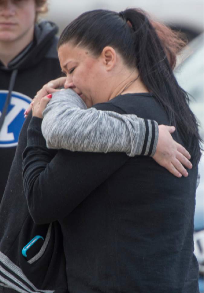 Rick Egan  |  The Salt Lake Tribune

Erika Shafta (right) hugs a family member Friday, Dec. 16, 2016, outside the home of where Gary Mecham, 77, and his wife Melba Mecham, 74, were killed in a fire late Thursday, in Woods Cross.