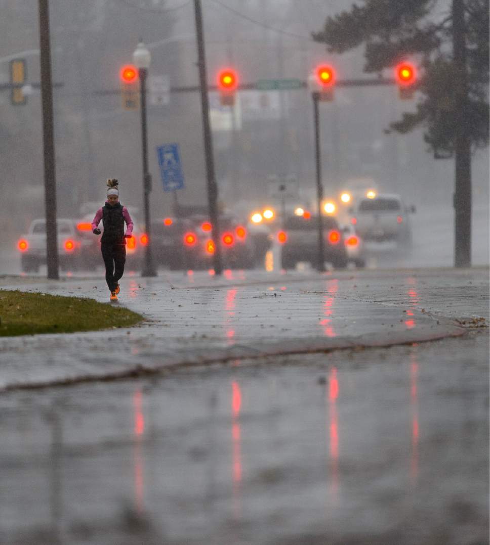 Trent Nelson  |  The Salt Lake Tribune
A jogger braves the rain on a run through Liberty Park in Salt Lake City Friday December 16, 2016.