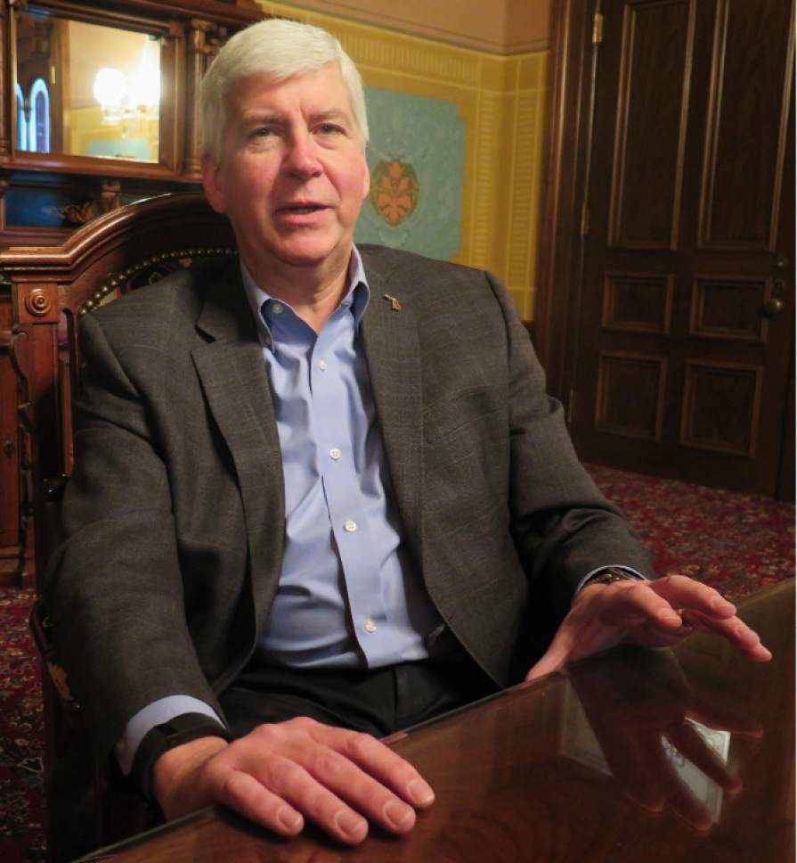 Michigan Gov. Rick Snyder speaks during a year-end interview on Wednesday, Dec. 14, 2016, in his office at the Michigan Capitol in Lansing. Snyder said he wants municipalities and labor unions to jointly study how best to tackle retiree health care costs after Republican lawmakers removed a contentious proposal to aggressively curb the benefits from the postelection agenda. (AP Photo/David Eggert)