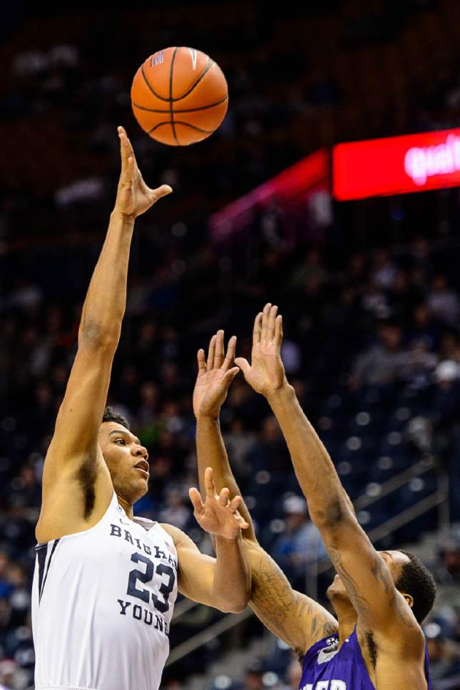 Trent Nelson  |  The Salt Lake Tribune
Brigham Young Cougars forward Yoeli Childs (23) shoots over Weber State Wildcats forward Kyndahl Hill (35) as BYU hosts Weber State, NCAA basketball at the Marriott Center in Provo, Wednesday December 7, 2016.
