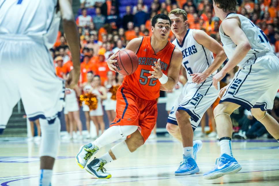 Chris Detrick  |  The Salt Lake Tribune
Brighton's Osa Masina (52) tries to run past Layton's Steel Roberts (5) and Layton's Cody Edwards (32) during the 5A championship game at the Dee Events Center Saturday February 28, 2015.  Brighton is winning the game 27-20 at halftime.