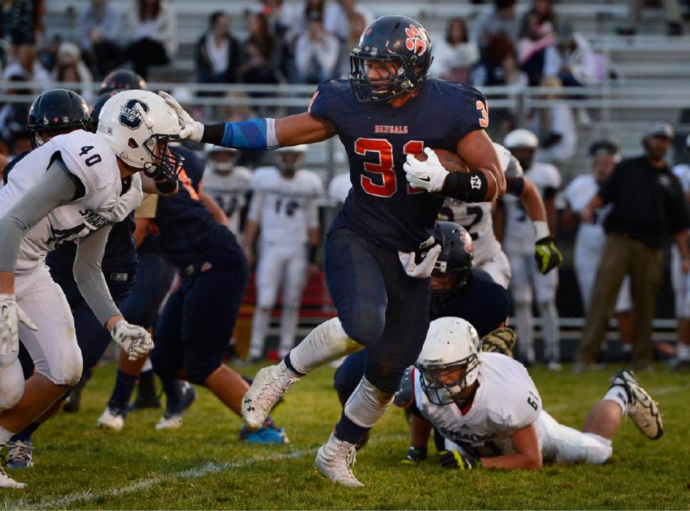 Scott Sommerdorf  |  The Salt Lake Tribune
Brighton RB Osa Masina ran for 117 yards, scored 2 TDs, and had an interception on defense. Brighton beat Syracuse 35-14 in a 5A first-round playoff game at Brighton, Friday, October 31, 2014.