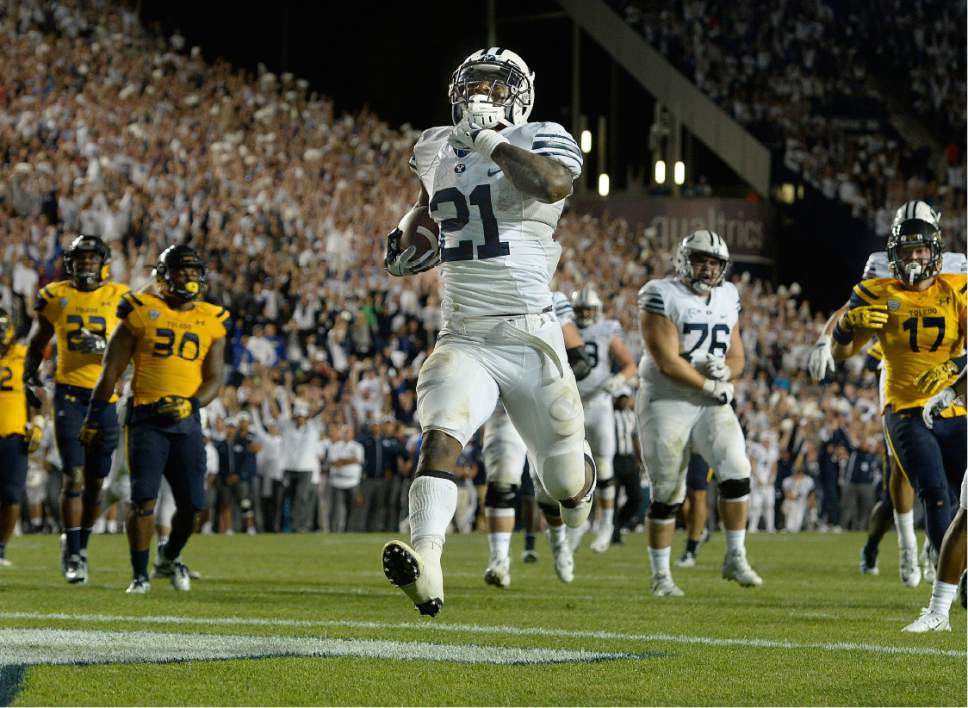Scott Sommerdorf   |  The Salt Lake Tribune  
BYU RB Jamaal Williams (21) scores his fifth TD on a 14 yard run to give BYU a 52-45 fourth quarter lead. BYU defeated Toledo 55-53, Friday, September 30, 2016.