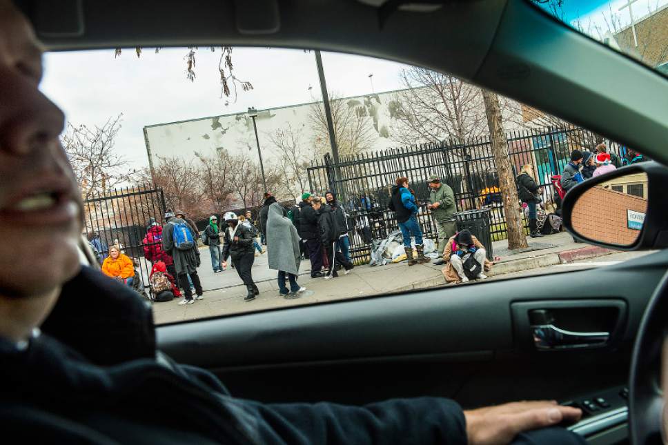 Chris Detrick  |  The Salt Lake Tribune
Metro Support Deputy Chief Fred Ross drives by Catholic Community Services of Utah as homeless menand women  wait outside Tuesday, Dec. 16, 2014.