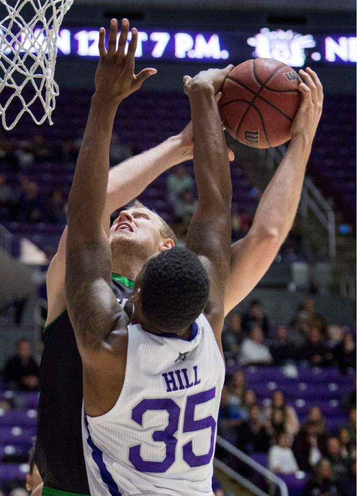 Rick Egan  |  The Salt Lake Tribune

Utah Valley Wolverines forward Isaac Neilson (22) takes a shot as Weber State Wildcats forward Kyndahl Hill (35) defends, in basketball action, Weber State Wildcats vs Utah Valley Wolverines, in Ogden, Saturday, December 17, 2016.