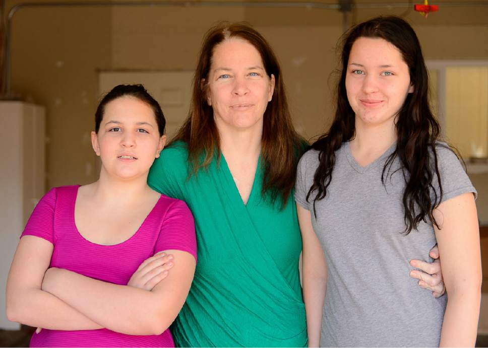 Trent Nelson  |  The Salt Lake Tribune
Kimberly Gross and her two daughters, Destiny Westman (left) and Petrina Westman (right), may soon be evicted from the basement apartment they found through The Road Home and its Rapid Rehousing program. They were photographed at home in Taylorsville Friday December 16, 2016.