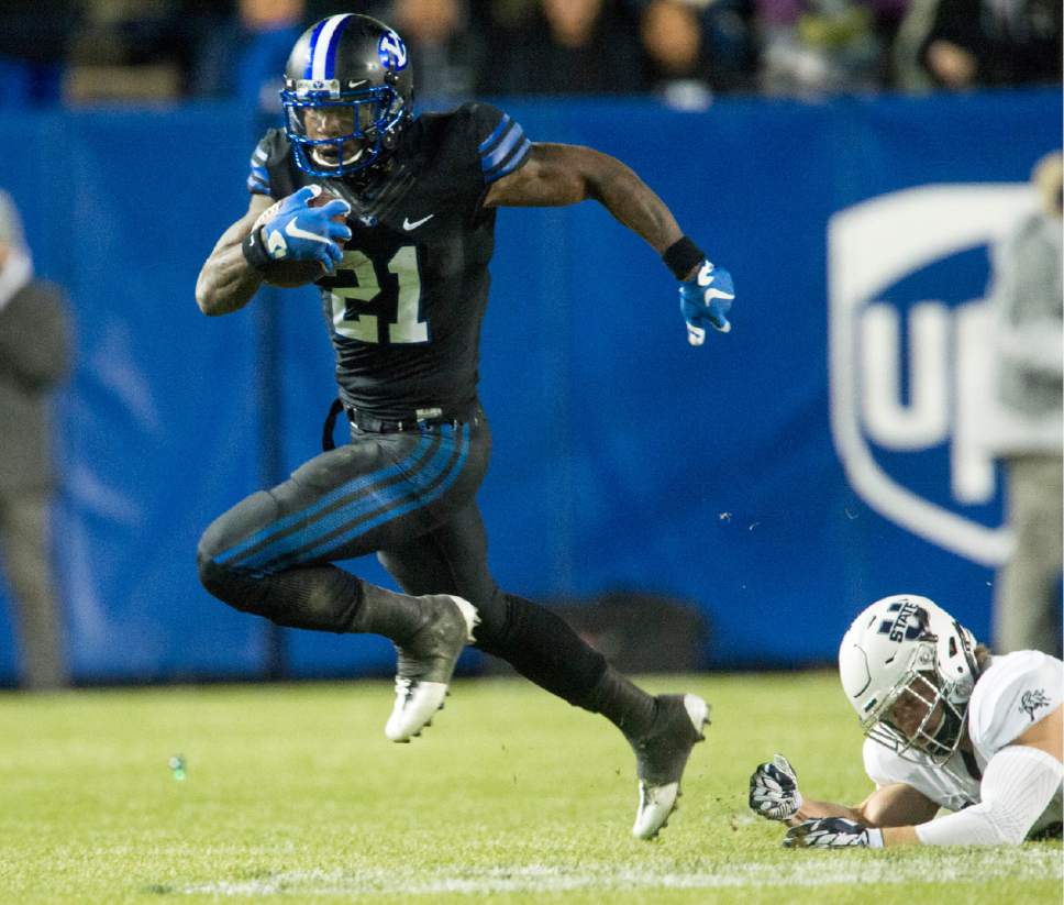 Rick Egan  |  The Salt Lake Tribune
Brigham Young running back Jamaal Williams (21) runs the ball for the Cougars against Utah State, at Lavell Edwards Stadium in Provo, on  Nov. 26, 2016.