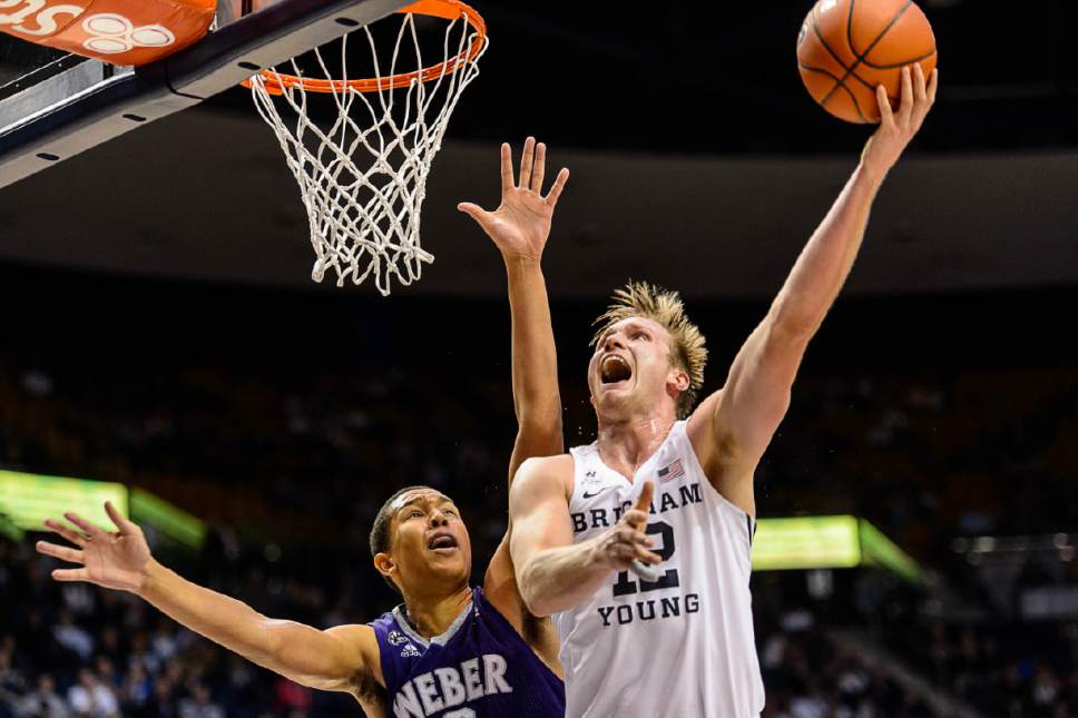 Trent Nelson  |  The Salt Lake Tribune
Brigham Young Cougars forward Eric Mika (12) shoots over Weber State Wildcats center Jordan Dallas (3) as BYU hosts Weber State, NCAA basketball at the Marriott Center in Provo, Wednesday December 7, 2016.