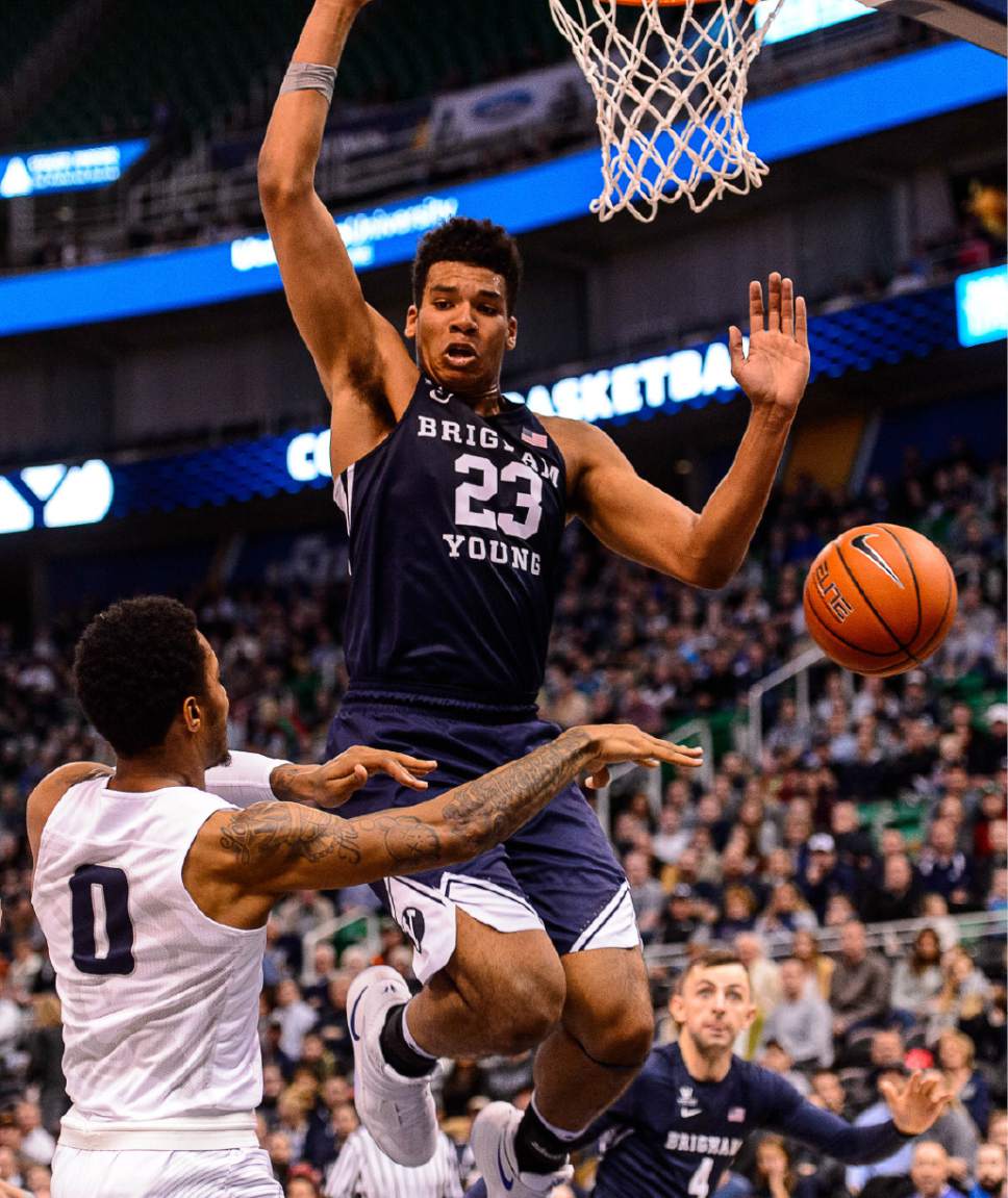 Trent Nelson  |  The Salt Lake Tribune
Utah State Aggies guard Shane Rector (0) passes around Brigham Young Cougars forward Yoeli Childs (23) as BYU faces Utah State, NCAA basketball in Salt Lake City, Wednesday November 30, 2016.