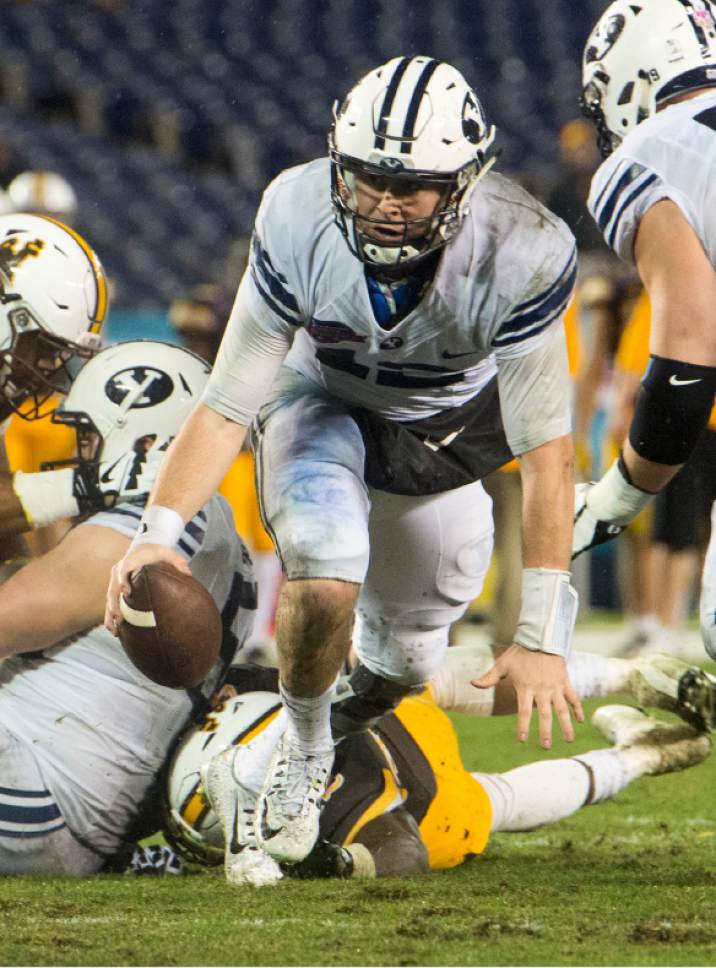Rick Egan  |  The Salt Lake Tribune

Brigham Young quarterback Tanner Mangum (12) scrambles before throwing a touchdown pass for the Cougars, in football action, Brigham Young Cougars vs. Wyoming Cowboys in the Poinsettia Bowl, at Qualcomm Stadium in San Diego, December 21, 2016.