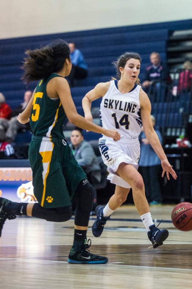 Chris Detrick  |  The Salt Lake Tribune
Skyline's Emma Clark (14) runs by Kearns' Ruby Maiava (25) during the game at Skyline High School Thursday December 22, 2016.