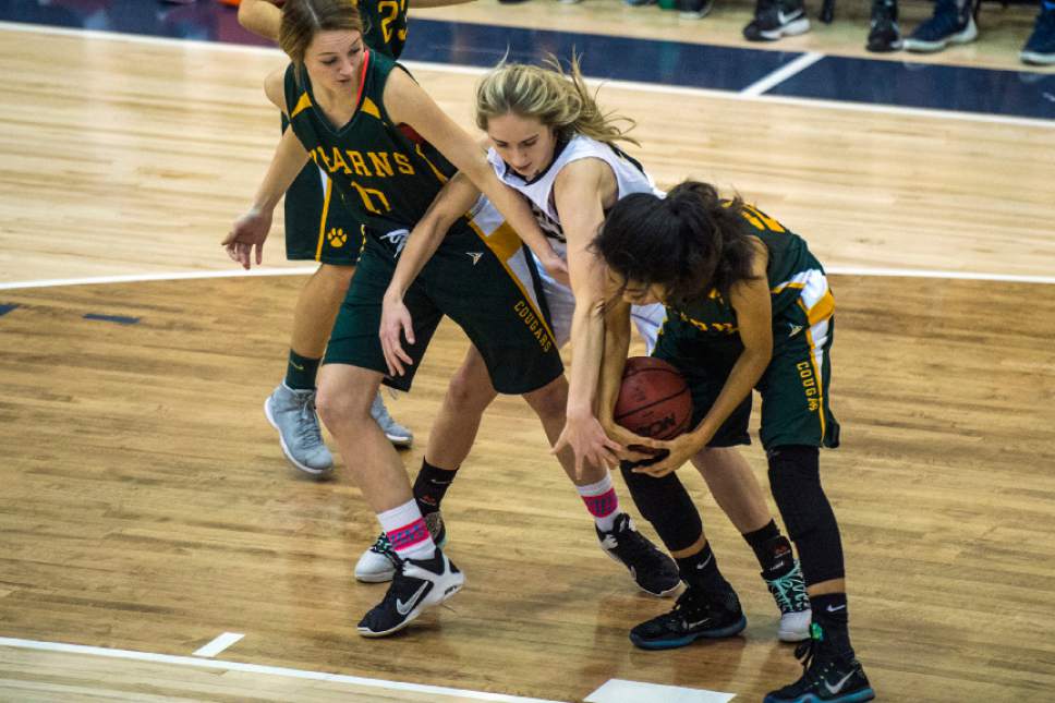 Chris Detrick  |  The Salt Lake Tribune
Kearns' Rachel Mastricola (12) Skyline's Hannah Anderl (15) and Kearns' Ruby Maiava (25) go for the ball during the game at Skyline High School Thursday December 22, 2016.