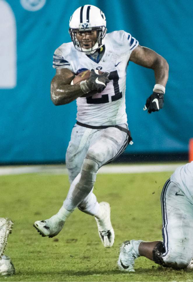 Rick Egan  |  The Salt Lake Tribune

Brigham Young Cougars running back Jamaal Williams (21) runs for a 36-yard touchdown for the Cougars, in football action, Brigham Young Cougars vs. Wyoming Cowboys in the Poinsettia Bowl, at Qualcomm Stadium in San Diego, December 21, 2016.