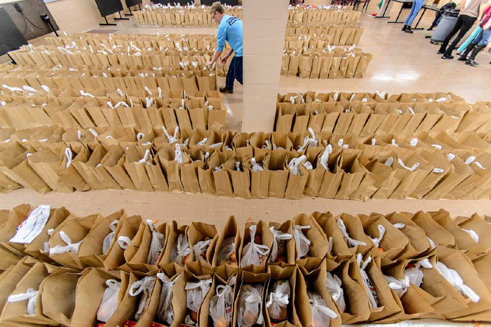 Trent Nelson  |  The Salt Lake Tribune
Volunteer William Stone organizes bags of food at the Rowland Hall & Crossroads Urban Center Holiday Meal Giveaway for Utah Families in Need in Salt Lake City, Friday December 23, 2016.