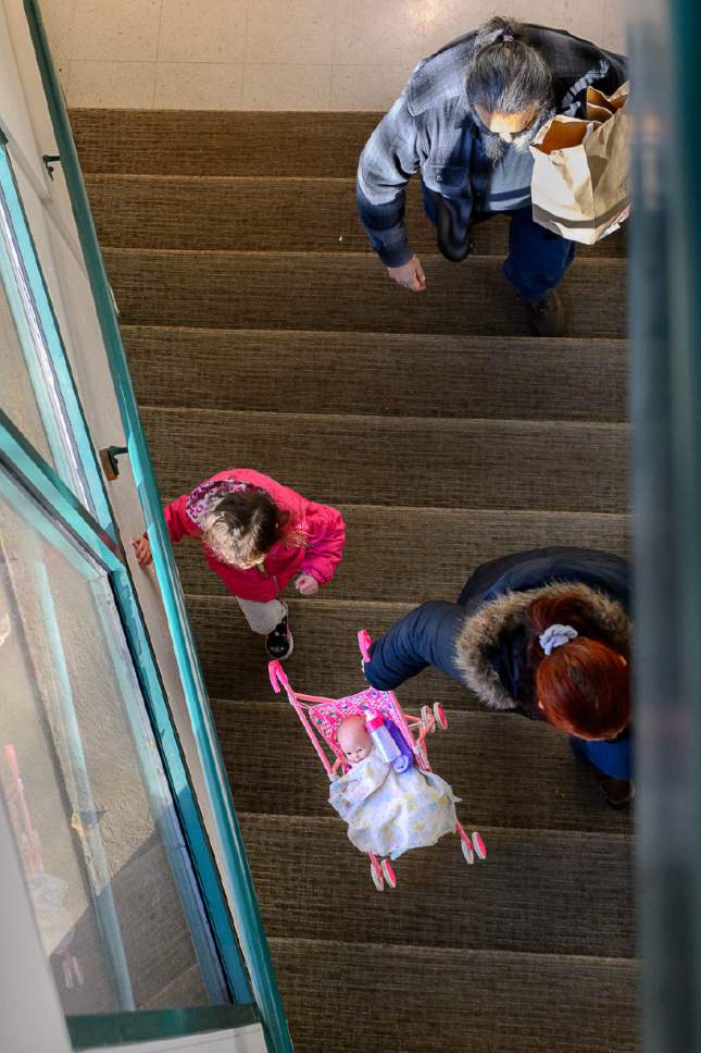 Trent Nelson  |  The Salt Lake Tribune
A family at the Rowland Hall & Crossroads Urban Center Holiday Meal Giveaway for Utah Families in Need in Salt Lake City, Friday December 23, 2016.