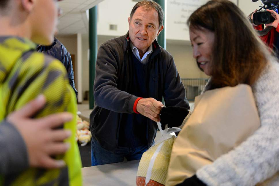 Trent Nelson  |  The Salt Lake Tribune
Governor Gary Herbert hands out turkeys at the Rowland Hall & Crossroads Urban Center Holiday Meal Giveaway for Utah Families in Need in Salt Lake City, Friday December 23, 2016.