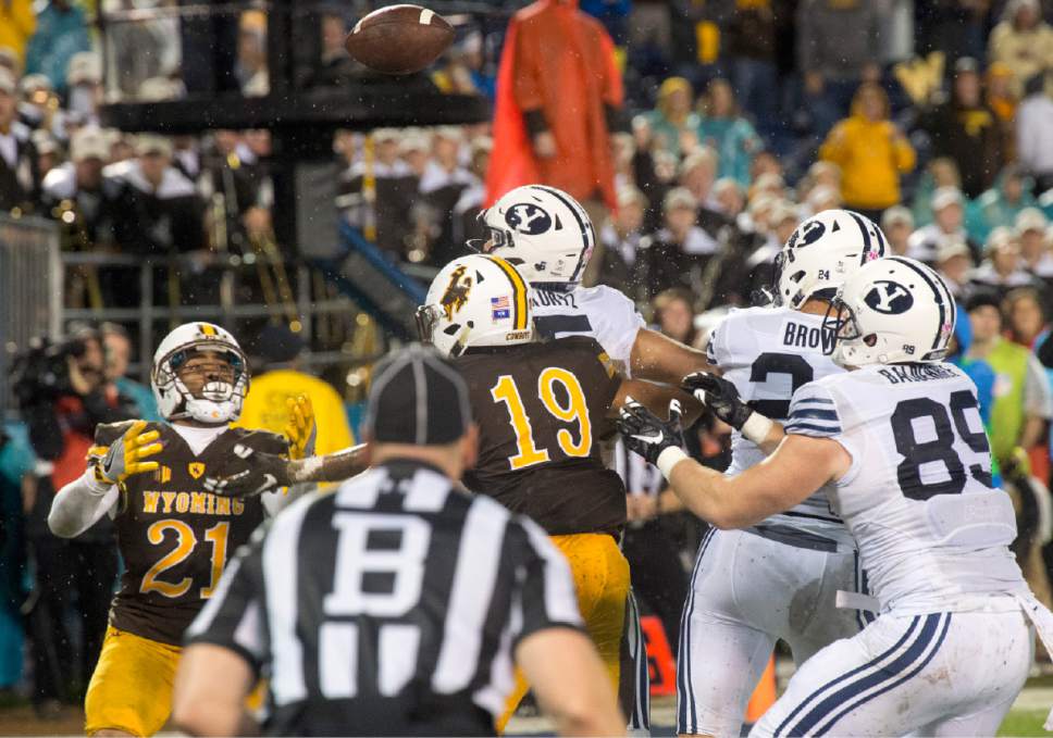 Rick Egan  |  The Salt Lake Tribune

Wyoming Cowboys cornerback Antonio Hull (21) tries to catch a pass in the end zone, as Brigham Young Cougars tight end Tanner Balderree (89) moves in to catch the ball after it was tipped, for a BYU touchdown, in the Poinsettia Bowl, at Qualcomm Stadium in San Diego, December 21, 2016.