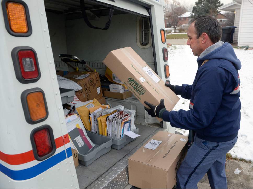 Al Hartmann  |  The Salt Lake Tribune
Postal carrier Ben Frost delivers mail and packages on his regular route in Murray Thursday Dec. 22, the U.S. Post Office's busiest delivery day of the year. A record-breaking 300,000 packages are expected to be delivered in Utah. Frost, a seasoned carrier expects long days and more mail and packages this time of year and just deals with it in stride.