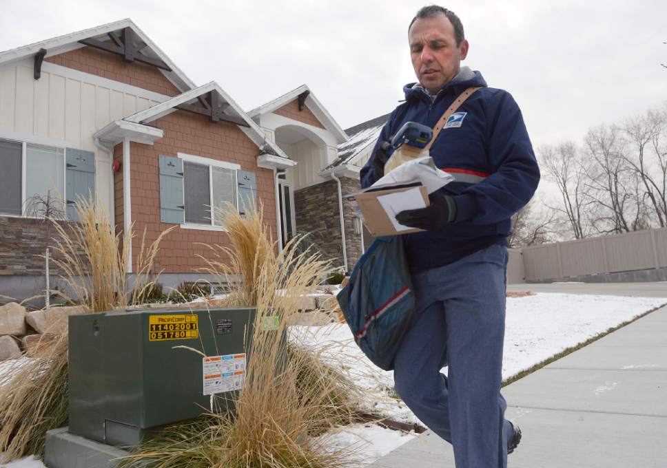 Al Hartmann  |  The Salt Lake Tribune
Postal carrier Ben Frost delivers mail and packages on his regular route in Murray Thursday Dec. 22, the U.S. Post Office's busiest delivery day of the year. A record-breaking 300,000 packages are expected to be delivered in Utah. Frost, a seasoned carrier expects long days and more mail and packages this time of year and just deals with it in stride.
