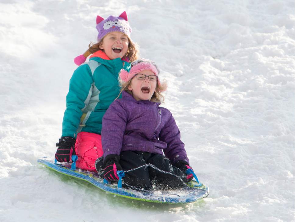 Rick Egan  |  The Salt Lake Tribune

Sisters, Lennon Smith 9, and Holland Smith 6, ride on a sled together at Liberty Park, Monday, December 26, 2016.