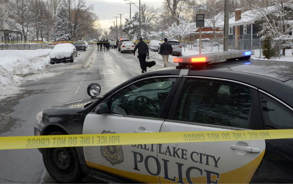Al Hartmann  |  The Salt Lake Tribune
Salt Lake City Police investigate homicide scene at 300 East Browning Street in Salt Lake City Tuesday Dec. 27.  Shots were fired just after 11 a.m. and a body was found in a car at the scene.  Police are on the lookout for two men believed to be involved in the shooting. They are still at large.