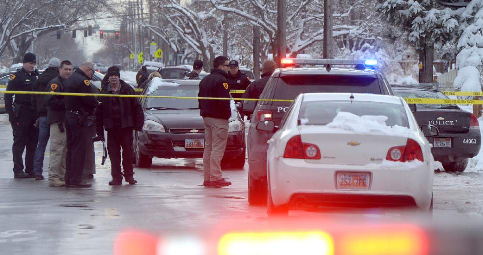 Al Hartmann  |  The Salt Lake Tribune
Salt Lake City Police investigate homicide scene at 300 East Browning Street in Salt Lake City Tuesday Dec. 27.  Shots were fired just after 11a.m. and a body was found in a car at the scene.  Police are on the lookout for two men believed to be involved in the shooting. They are still at large.